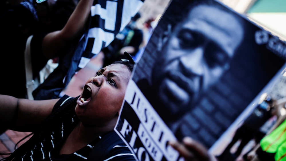 A protester reacts while gathering with others outside the city hall in Minneapolis