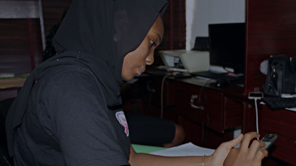 At the firm’s tiny office, Hairat Suleiman attempts to contact inmates’ families
