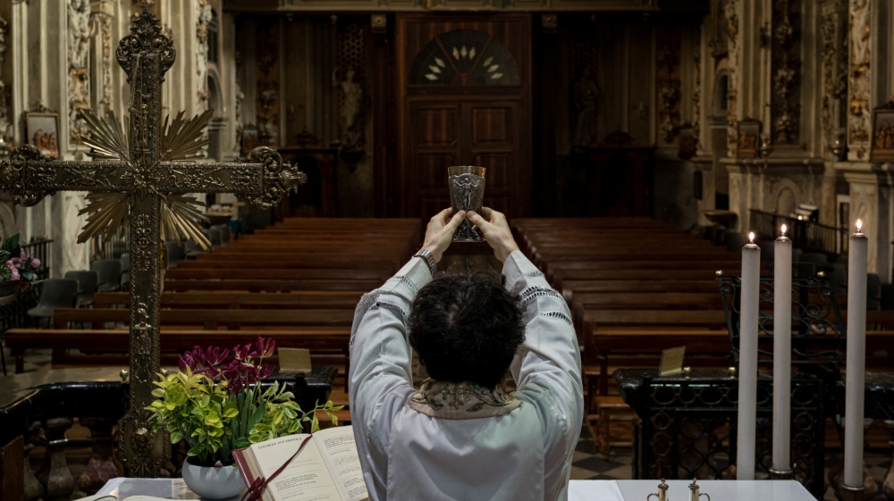 Priest Don Giuseppe leads a Mass to an empty church in San Fiorano in northern Italy