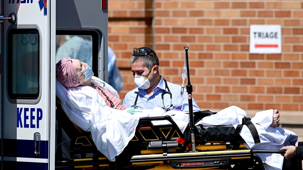 Medical workers transport a patient outside a special COVID-19 area at Maimonides Medical Center on May 14, 2020 in the Borough Park neighborhood of Brooklyn in New York City. (Photo by Johannes EISEL