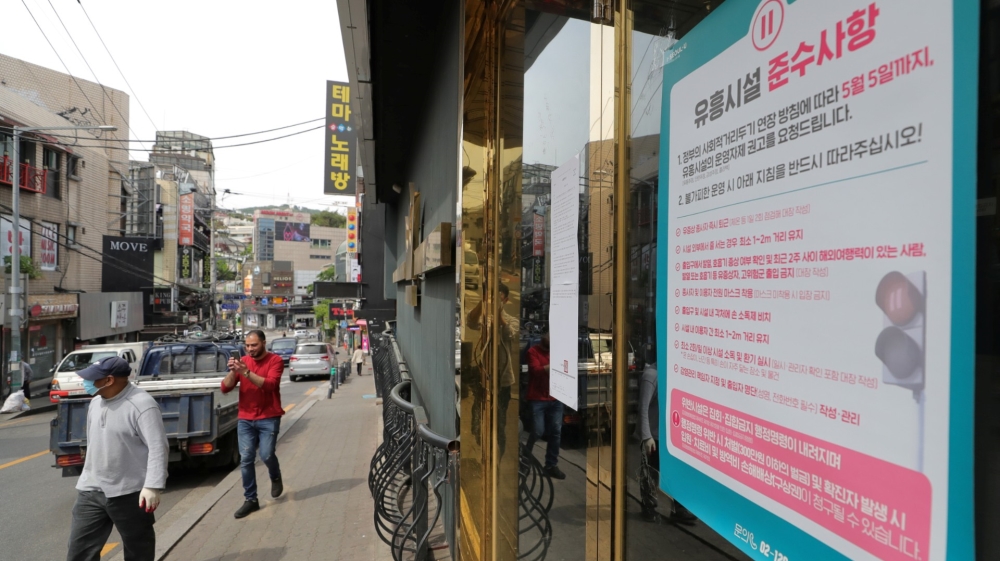 A list of precautions to prevent the spread of the coronavirus disease is seen at an entrance of a club in Seoul [Yonhap via Reuters]