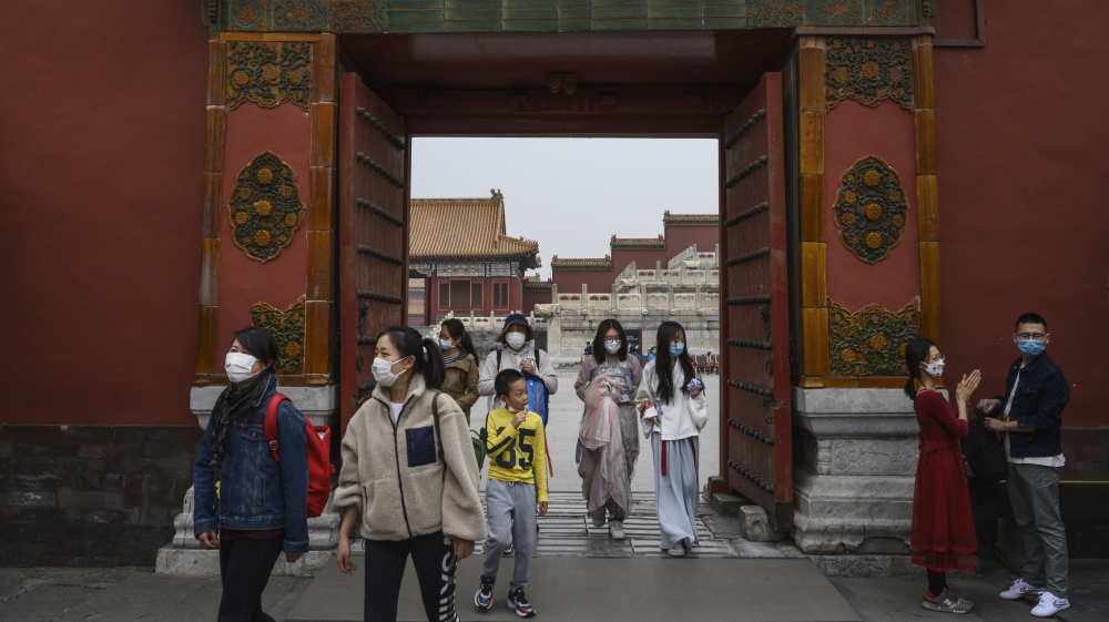 Visitors wear protective masks as they tour the Forbidden City, which recently reopened to limited visitors, in Beijing, China