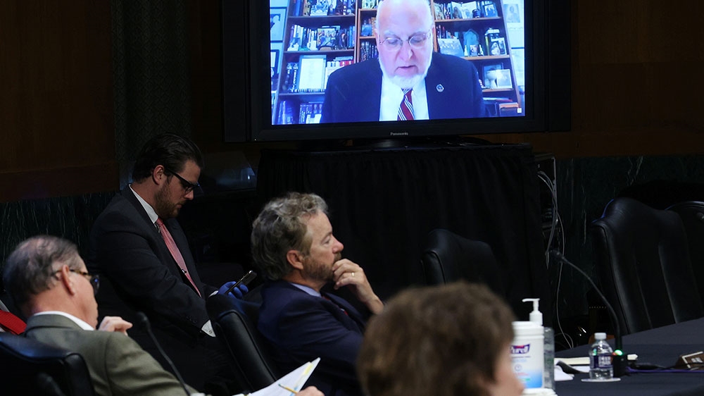 US Senators and staff listen to Dr Robert Redfield, director of the Centers for Disease Control and Prevention, as he speaks remotely during the Senate Committee for Health, Education, Labor, and Pensions hearing on the coronavirus disease (COVID-19) response