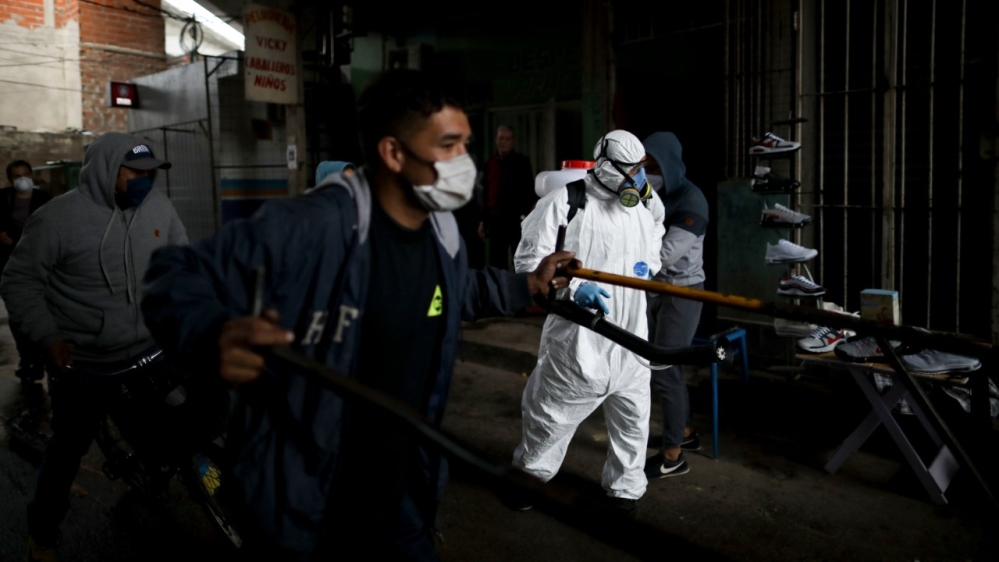 A man disinfects a street in the “Villa 31” neighbourhood of Buenos Aires, Argentina on Wednesday