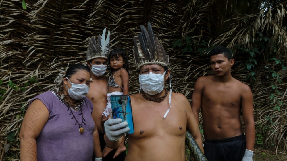 Satere-mawe indigenous people are seen using a smartphone to contact a doctor in Sao Paulo state to receive medical guidance amid the COVID-19 pandemic at the Sahu-Ape community, near Manaus, Amazonas State, Brazil, on May 5, 2020