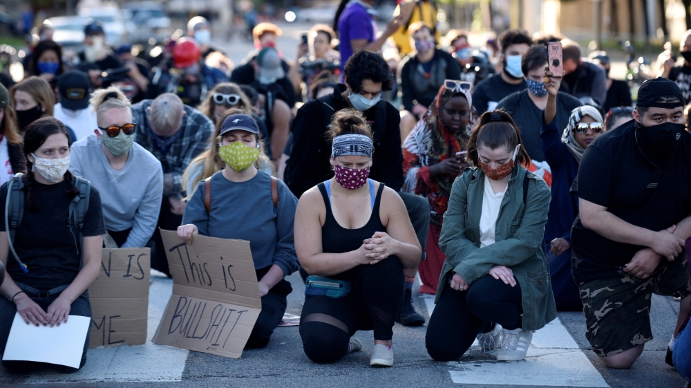 Peaceful demonstrators observe a moment of silence outside the US Bank Stadium during the fourth day of protests after the killing of George Floyd in Minneapolis, Minnesota, US on May 29, 2020