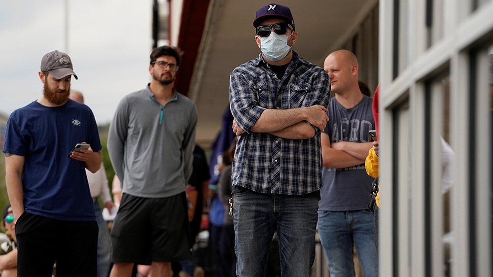 People who lost their jobs as coronavirus lockdown measures swept the United States wait in line to file for unemployment benefits
