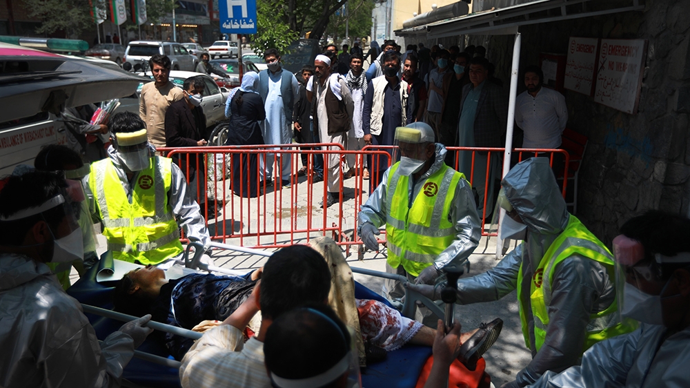 epa08416063 An Afghan woman is brought to Emergency hospital for medical treatment after she was injured during an attack at an MSF (Doctors without Borders) clinic in Kabul, Afghanistan, 12 May 2020.