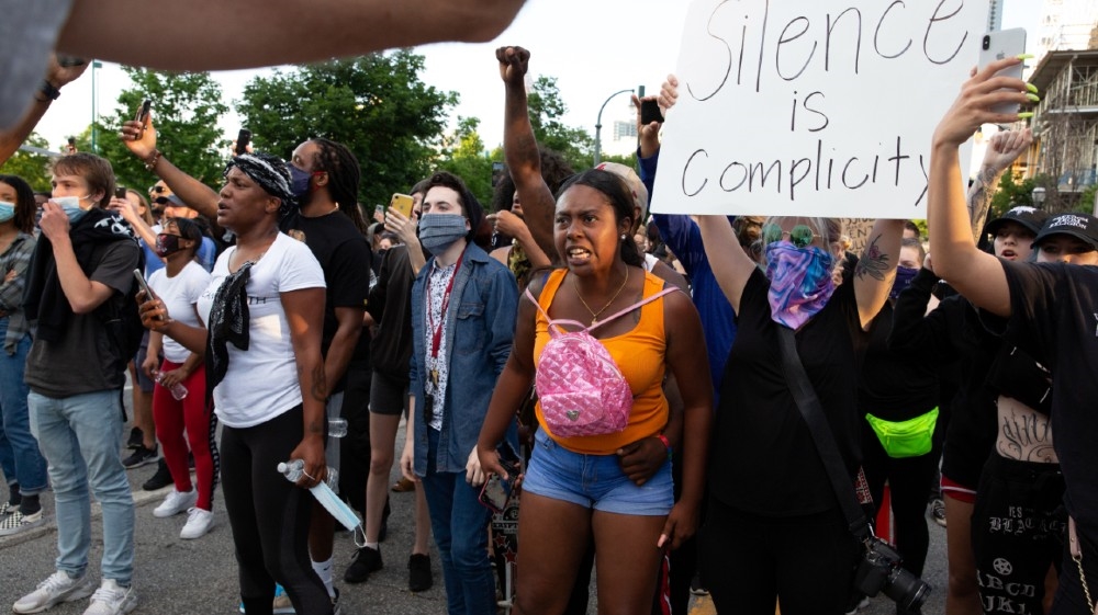 Protesters throw firecrackers amid tear gas during a protest against the death in Minneapolis police custody of George Floyd, in Atlanta, U.S., May 30, 2020. 