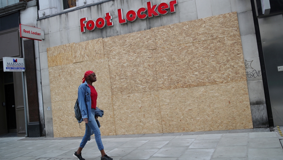 Shops are seen boarded up in Oxford Street, in London