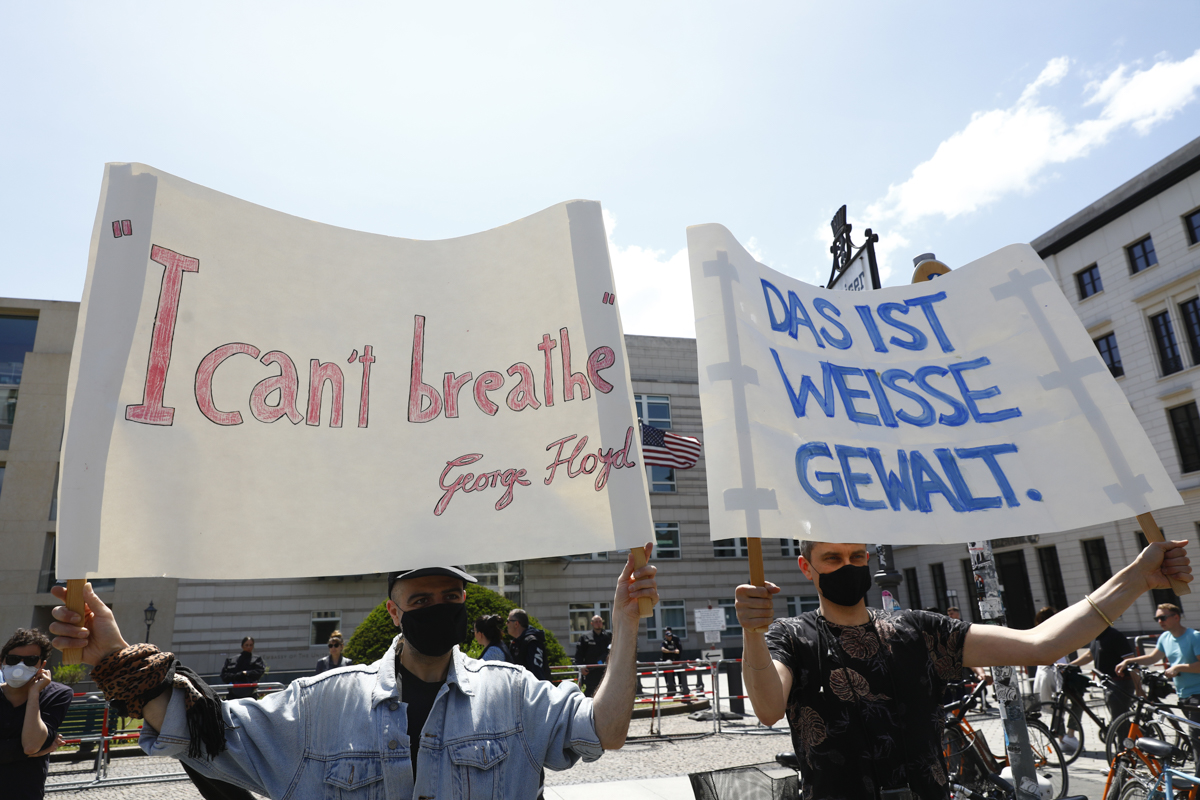 epa08455867 Supporters of the Black Lives Matter movement hold placards and banners to protest against the police brutality in the US following the death of George Floyd, in front of the US Embassy to