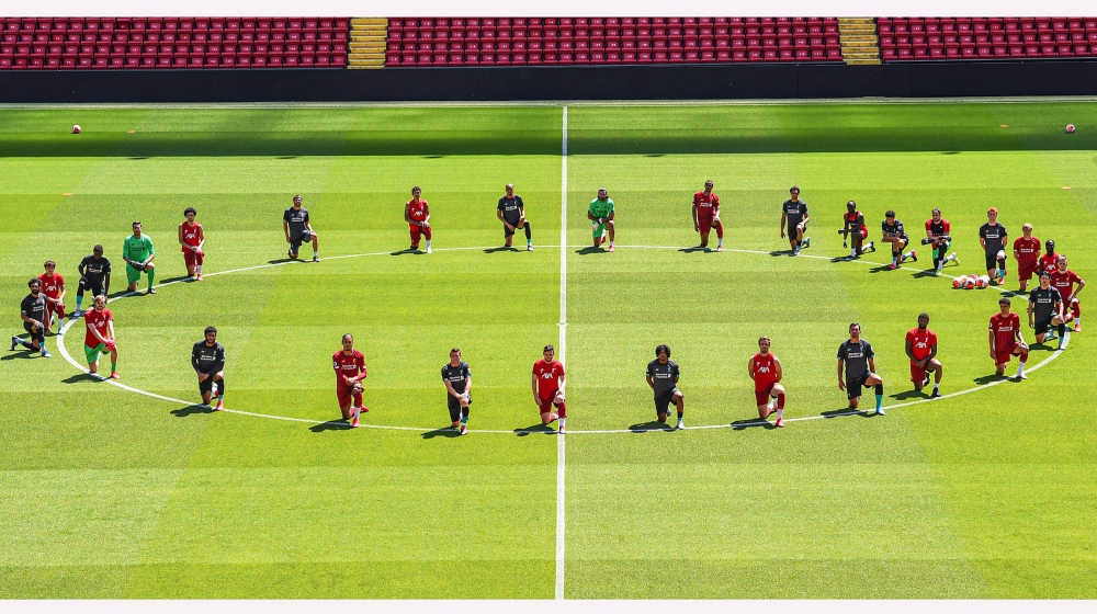 Liverpool players take a knee in memory of George Floyd at Anfield on June 01, 2020 in Liverpool, England.