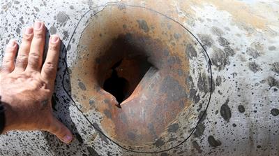 A hole in a damaged pipeline is seen at Saudi Aramco oil facility in Khurais following an aerial attack in September 2019 that knocked out of half of the kingdom’s oil production