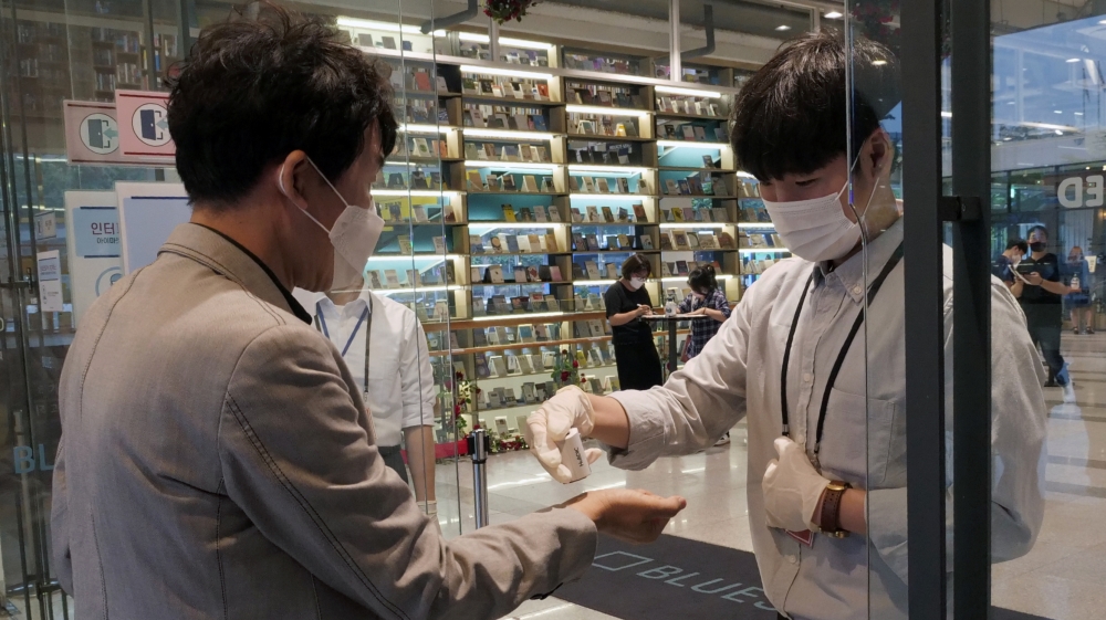 A man sanitises his hands before entering a cheater for Phantom of the Opera as the spread of the coronavirus disease (COVID-19) continues, in Seoul