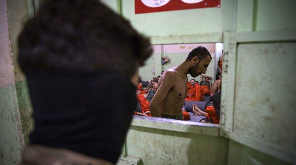 A member of the Syrian Democratic Forces looks into a prison cell in Hasakah. Kurdish sources say some 12,000 ISIL fighters including Syrians, Iraqis and 54 other nationalities are held in Kurdish-run prisons in northern Syria