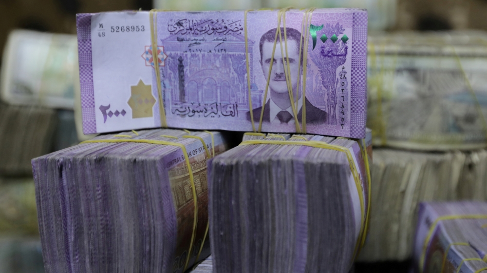 Syrian pounds are pictured inside an exchange currency shop in Azaz, Syria February 3, 2020. Picture taken February 3, 2020. REUTERS/Khalil Ashawi/File Photo