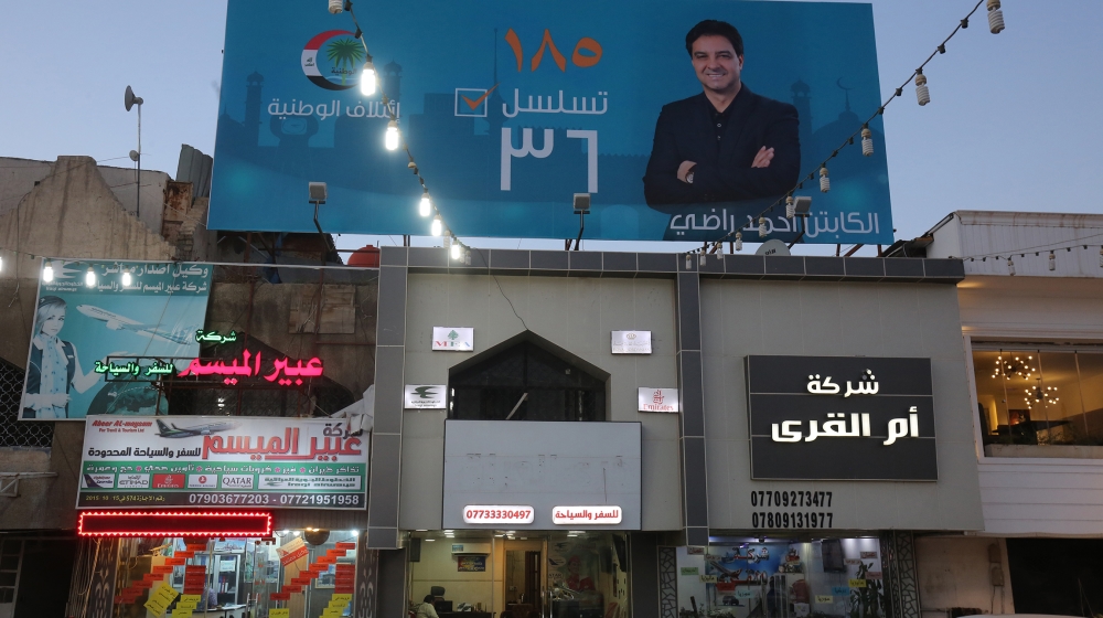 In this file photo taken on April 23, 2018 shows the campaign poster of Ahmed Radhi, a former Iraqi footballer, hanging in a street in Baghdad. Iraqi football legend Ahmed Radhi died on June 21, 2020
