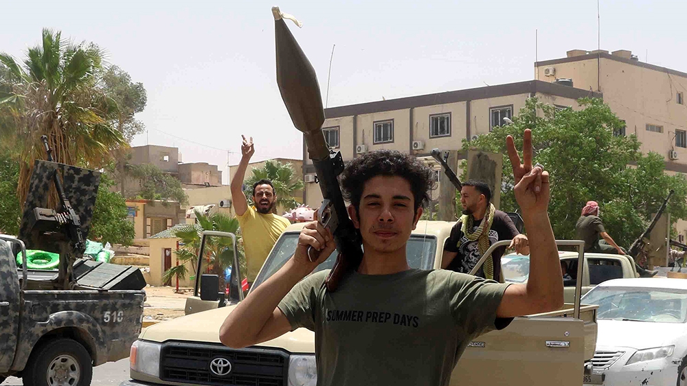 epaselect epa08467426 Fighters loyal to the United Nations-recognized Libyan Government of National Accord (GNA) pose for a picture after the area was taken over by GNA-aligned forces following clashe