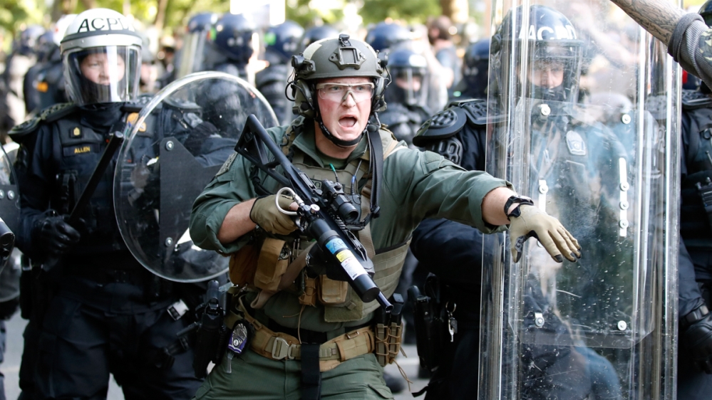 Police begin to clear demonstrators gathered as they protest the death of George Floyd, Monday, June 1, 2020, near the White House in Washington. Floyd died after being restrained by Minneapolis polic