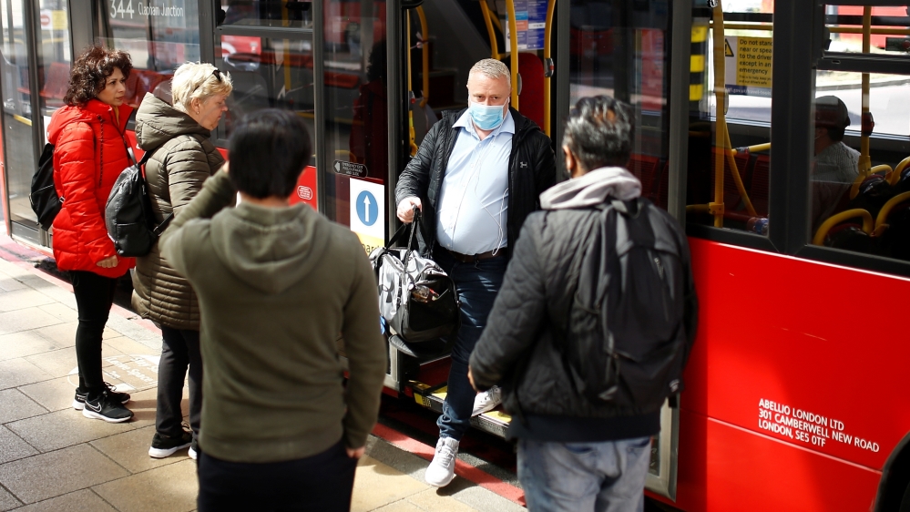 A man exits a bus wearing a protective face mask at Vauxhall bus station in London, Britain, May 14, 2020