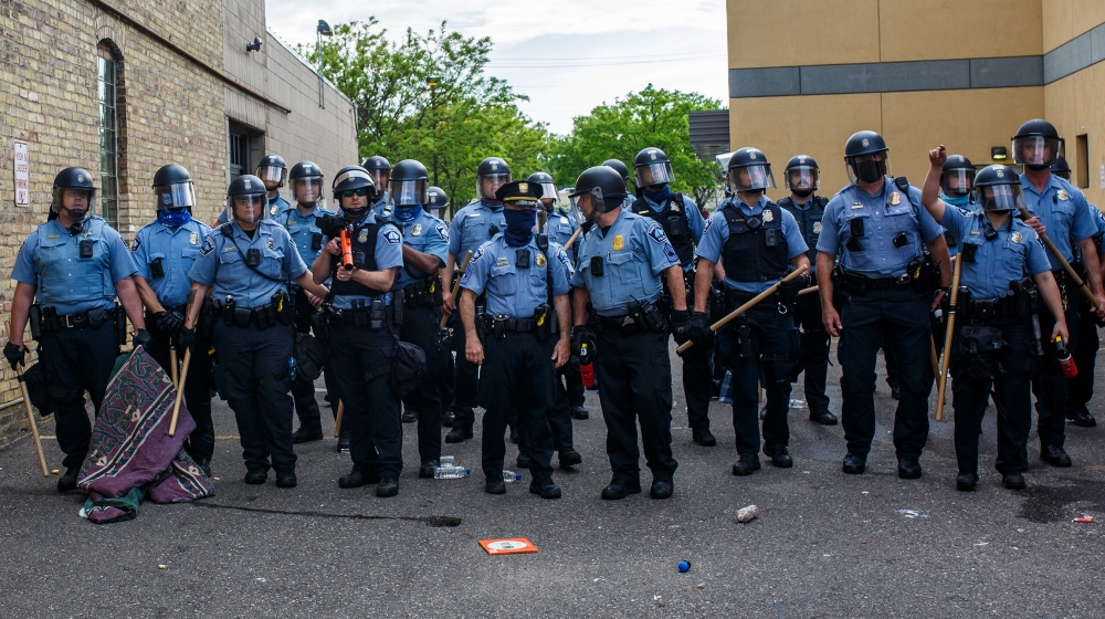 Minneapolise Police officers stand in a line while facing protesters demonstrating against the death of George Floyd outside the 3rd Precinct Police Precinct in Minneapolis, Minnesota. Members of the