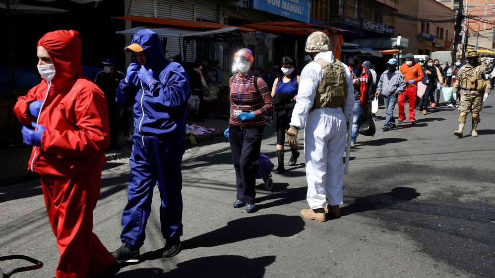People line up to enter a market in La Paz, Bolivia