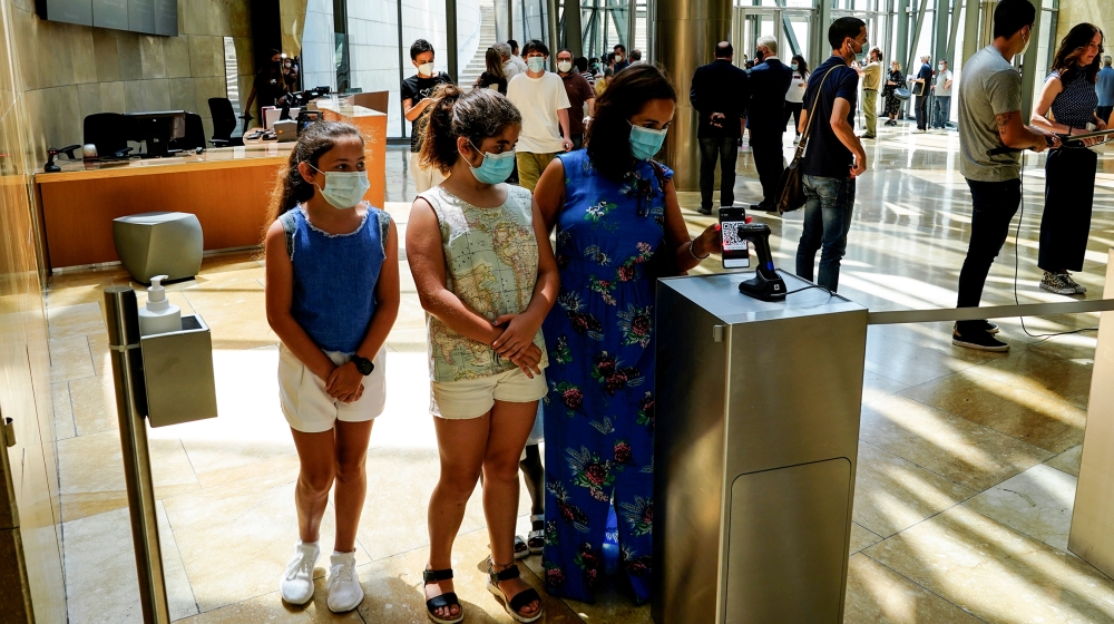 Visitors use an app to enter the Guggenheim Museum on the day it reopens its doors following a three-month closure, amid the coronavirus disease (COVID-19) outbreak, in Bilbao, Spain, June 1, 2020. RE