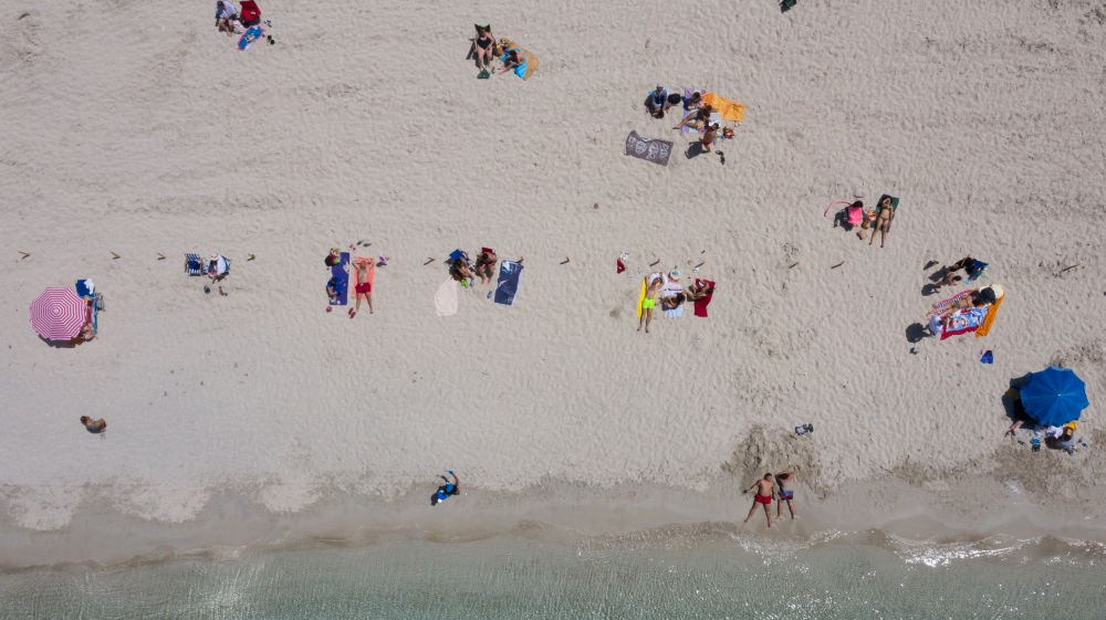 A drone photo shows an aerial view of Ilica beach as people enjoy their time in Cesme during the first weekend without coronavirus restrictions since April 10, in Izmir province of Turkey