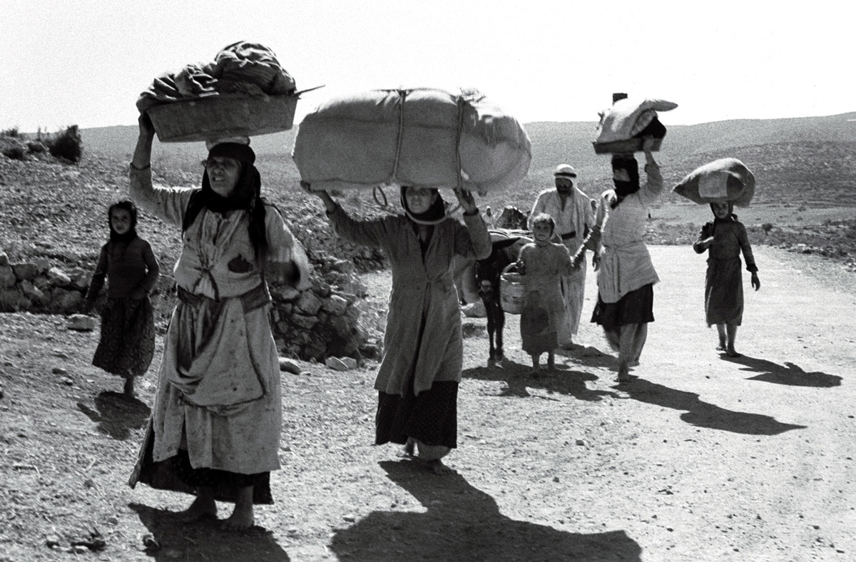 Palestinians carrying possessions on their heads as they flee from an unidentified village in Galilee some five months after the creation of the state of Israel in 1948 [File: Reuters]
