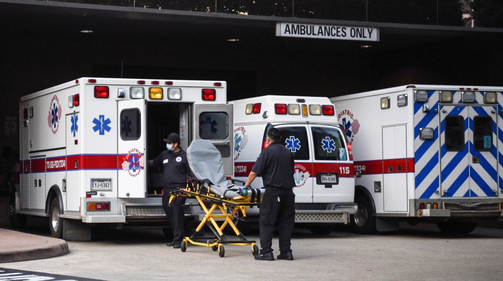 Healthcare workers place a stretcher inside an ambulance at Texas Children's Hospital as cases of the coronavirus disease (COVID-19) spike in Houston, Texas, U.S., July 8, 2020. REUTERS/Callaghan O'Ha