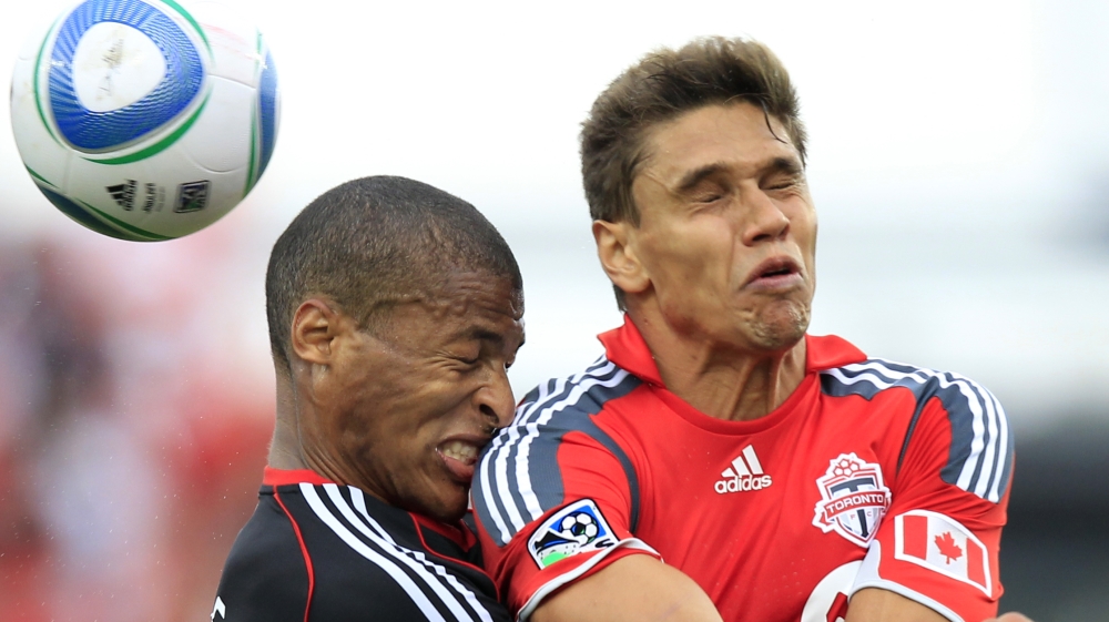 DC United defender Jordan Graye collides with Toronto FC defender Adrian Cann during their MLS soccer game in Toronto