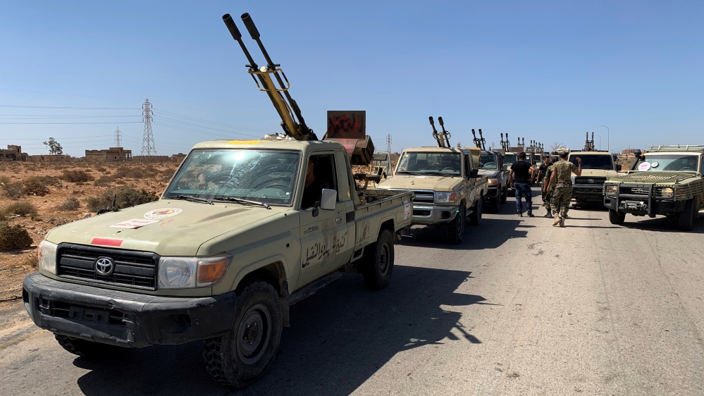 Troops loyal to Libya''s internationally recognized government are seen in military vehicles as they prepare before heading to Sirte