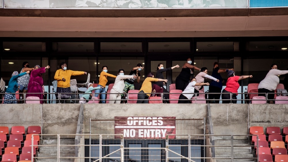 Recovering COVID-19 coronavirus patients attend a fitness class hosted by Fitness Instructor Loyolo Thandani (not visible) at the Nelson Mandela Bay Stadium government