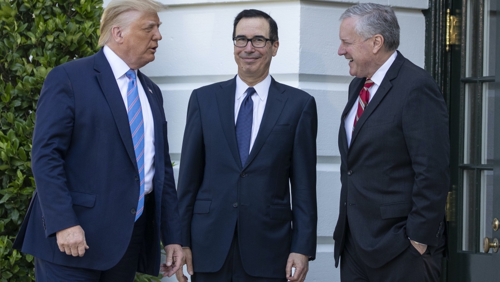US President Donald Trump, Treasury Secretary Steven Mnuchin, and White House Chief of Staff Mark Meadows talk before Trump speaks with reporters on the South Lawn of the White House on Wednesday in Washington, DC, the US