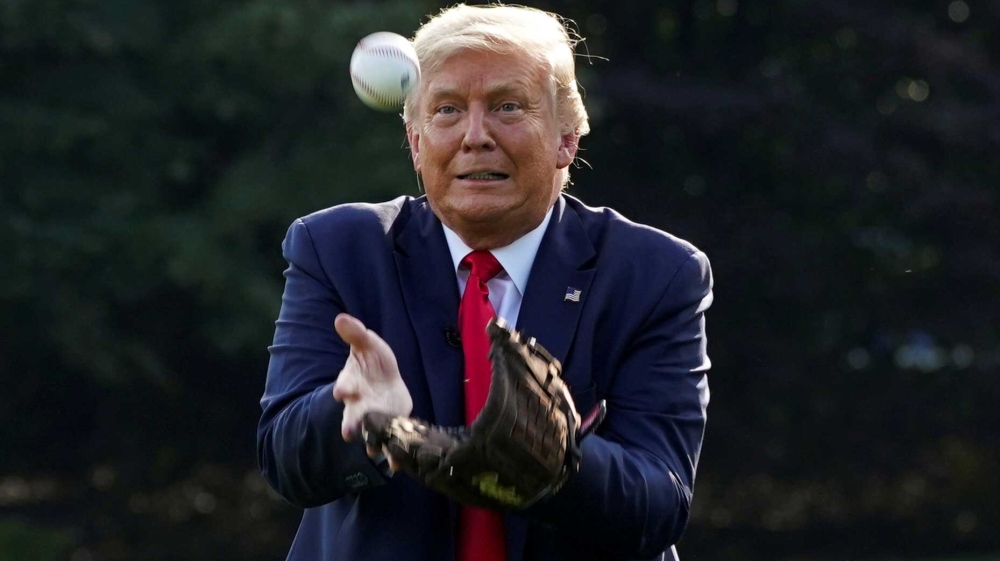 US President Donald Trump catching a ball while hosting youth baseball players at the White House on opening day for Major League Baseball on July 23, 2020, in Washington, DC, the US