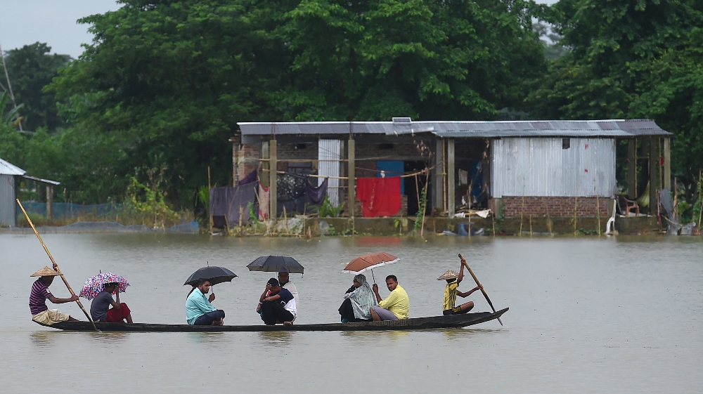 BANGLADESH-INDIA-NEPAL-WEATHER-FLOOD  People ride on a boat through flooded waters in Sunamgong on July 14, 2020. Almost four million people have been hit by monsoon floods in South Asia