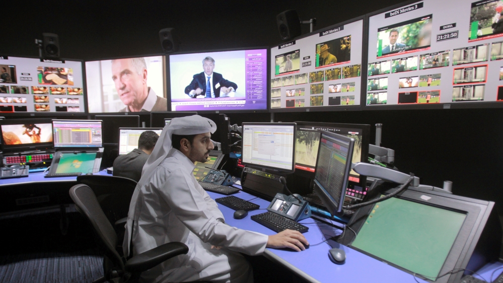 Employees work in a broadcast control room at the beIN Sports studio that will be hosting the 2022 FIFA World Cup in Doha