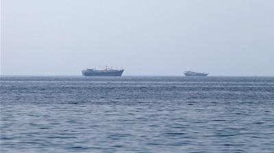 Traditional Omani boats known as dhows are seen sailing towards the Strait of Hormuz
