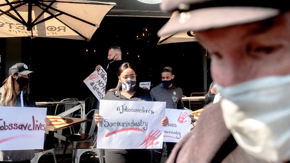 Restaurant workers gather in Parkhurst, Johannesburg, to join a national protest organized by the Restaurant Association of South Africa (RASA) against the national lockdown regulations the government issued to fight the rise of COVID-19