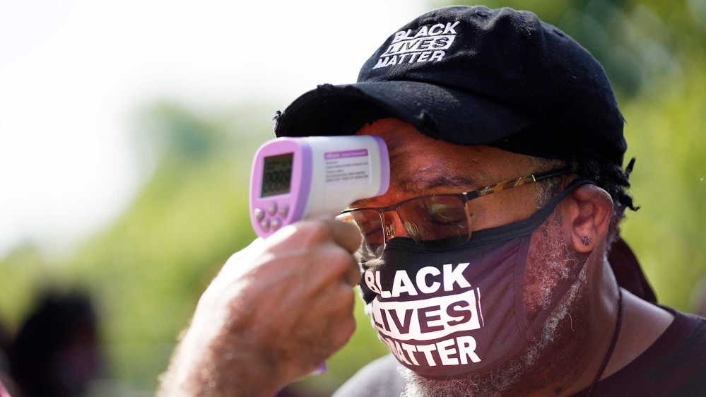 People attending the march have their temperatures checked before entering the Lincoln Memorial in Washington, on the 57th anniversary of the Reverend Martin Luther King Jr’s ‘I Have A Dream’ speech