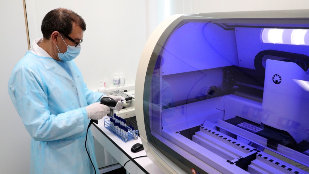 A laboratory worker checks the coronavirus tests at the CHIREC Delta Hospital in Brussels