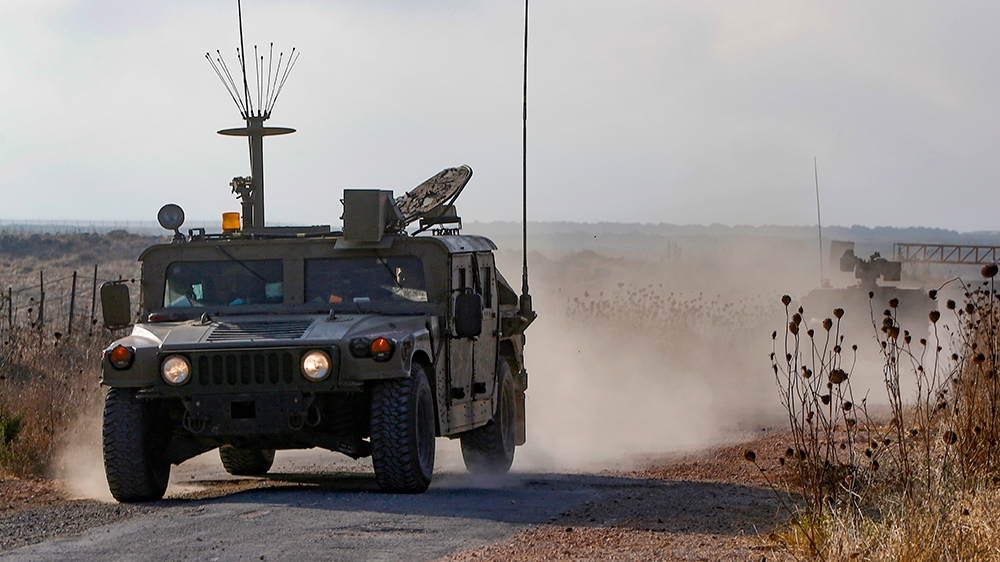An Israeli military vehicle patrols near the Syria border in the Israeli-annexed Golan Heights on August 3, 2020, near the location where the army said it killed four men laying explosives at a securi