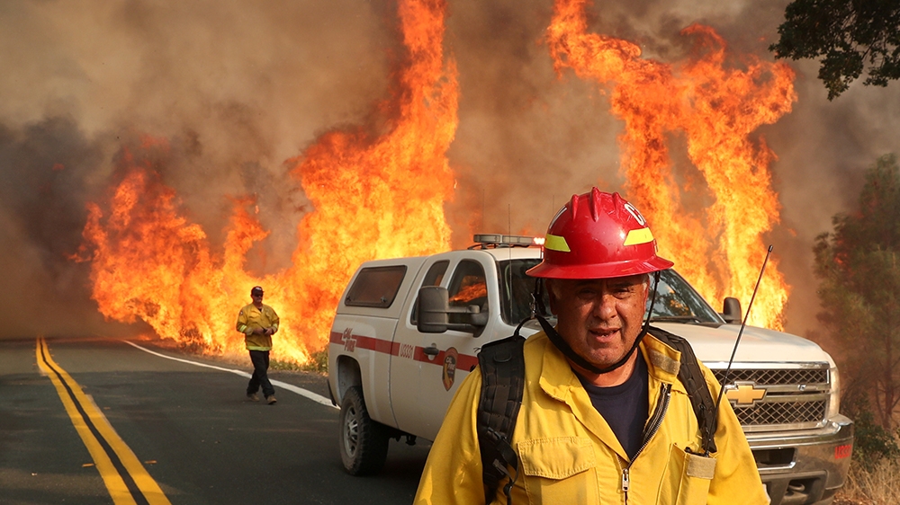 Chula Vista firefighter Rudy Diaz monitors the LNU Lightning Complex Fire as it engulfs brush in Lake County, California, U.S. August 23, 2020. REUTERS/Adrees Latif     TPX IMAGES OF THE DAY