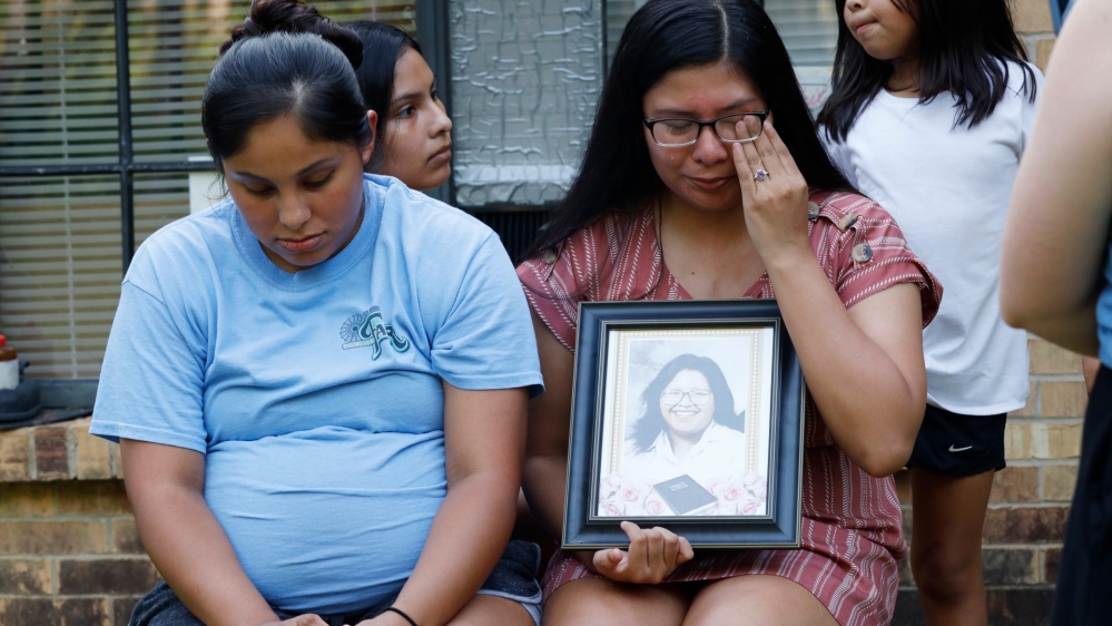 Kristina Taylor, 18, cries as she holds a portrait of her late mother, Sharon Taylor, who never saw Kristina, the class valedictorian at Choctaw Central High School, graduate