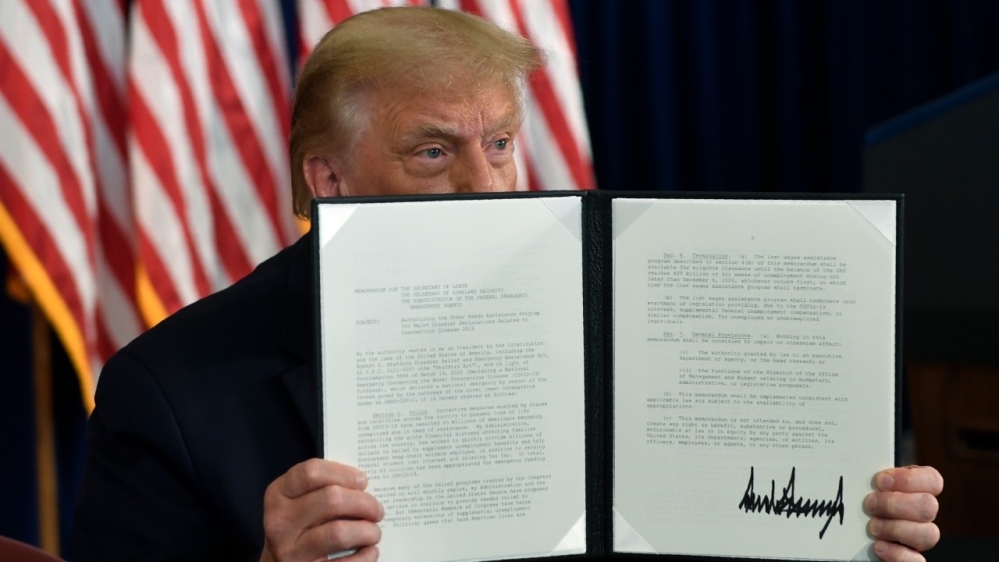 President Donald Trump signing an executive order during a news conference at the Trump National Golf Club in Bedminster, New Jersey, the US