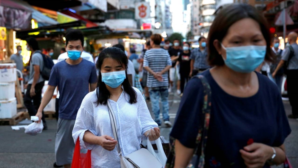 People wear surgical masks at a wet market at Sham Shui Po, Hong Kong