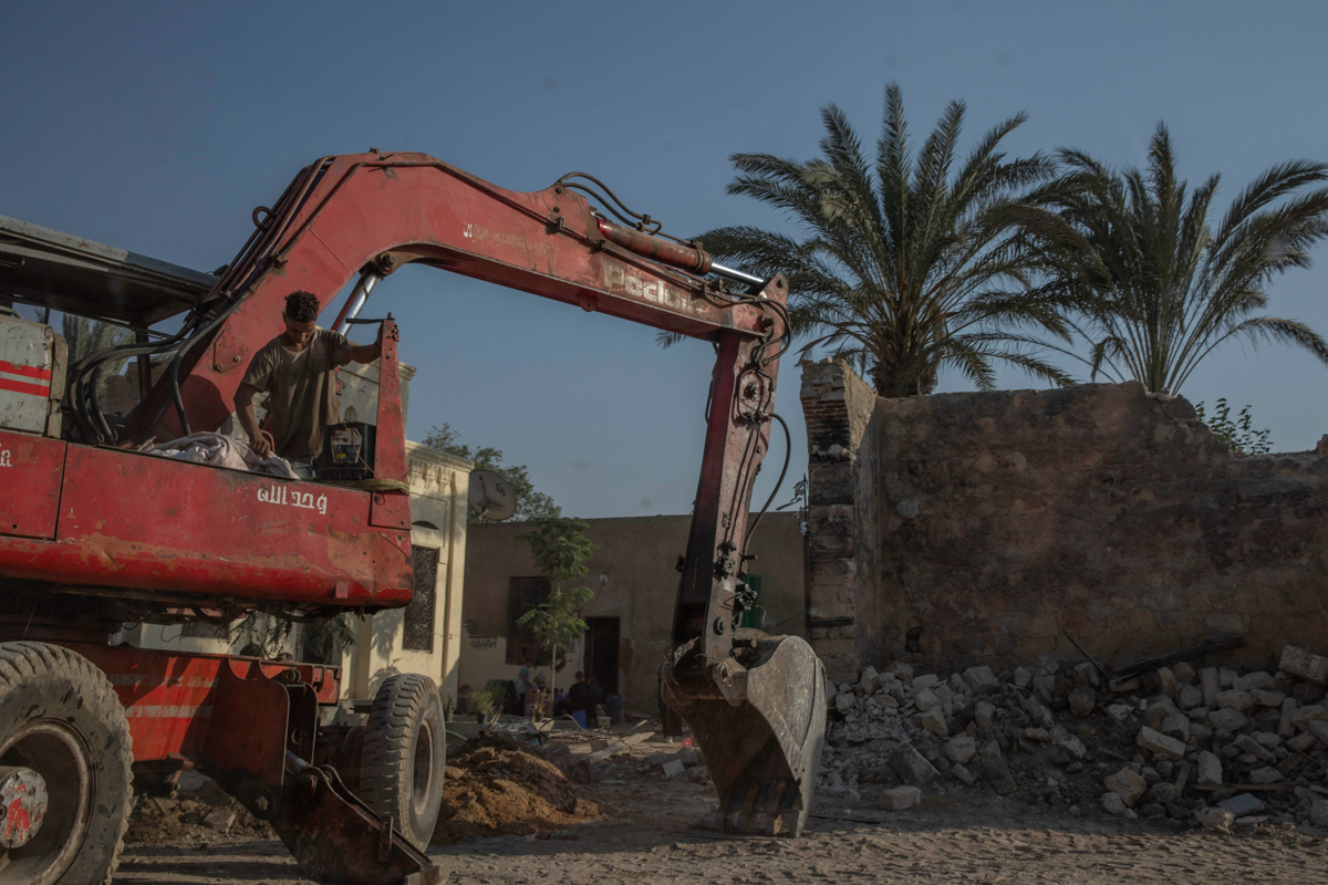 Construction workers knock down walls of family mausoleums to clear way for a new highway running through the historic Northern Cemetery in Cairo, Egypt, Tuesday, July 21, 2020. Dozens of graves have