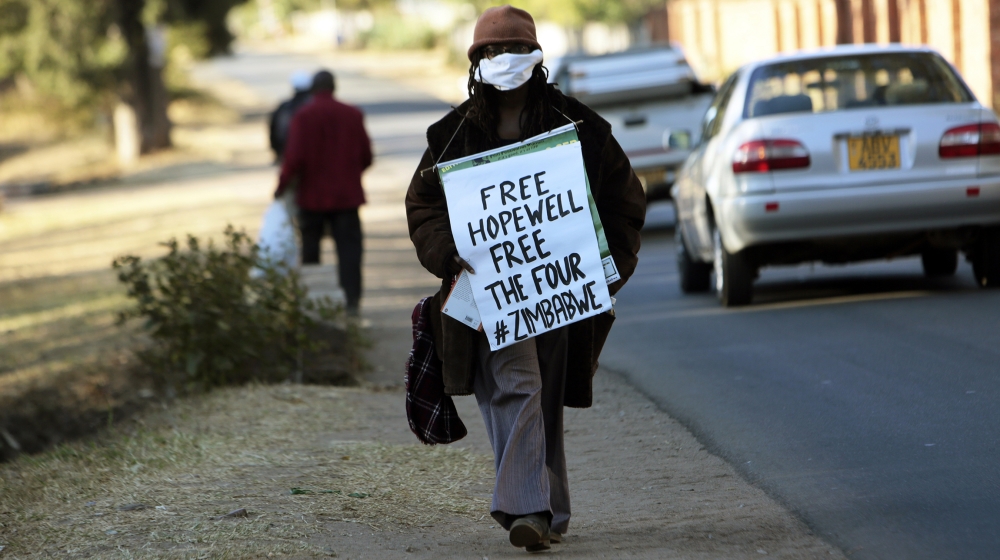 Zimbabwean writer and filmaker Tsitsi Dangarembwa demonstrates outside Hopwell Chin'onos house in Harare, Monday, July 20, 2020. Lawyers say Zimbabwe police have swooped in and detained a prominent j