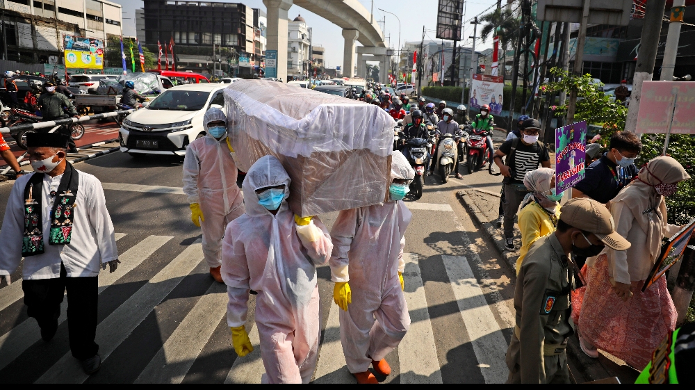Indonesia has been hard hit by the coronavirus compared with other countries in ASEAN with the exception of the Philippines Government officials have taken to using mock coffins in a stark campaign to educate people about the risks of the disease