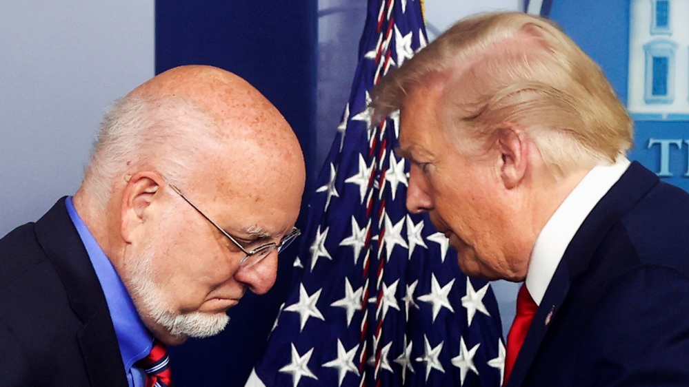 U.S. President Trump gives the podium to CDC Director Redfield to address the daily coronavirus disease (COVID-19) outbreak task force briefing at the White House in Washington